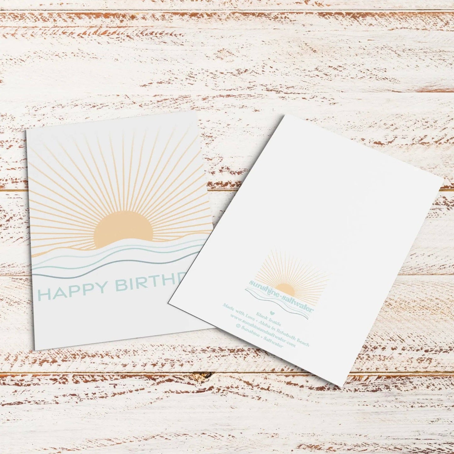 Birthday card with sun design on a wooden surface
