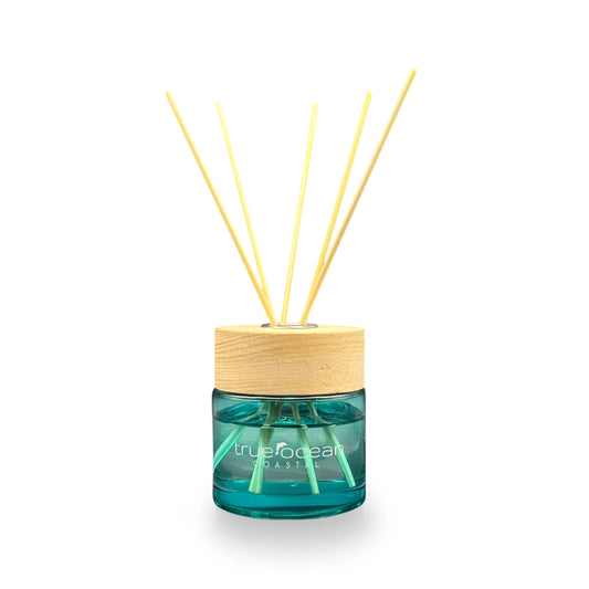 Reed diffuser with wooden cap and blue container on a white background