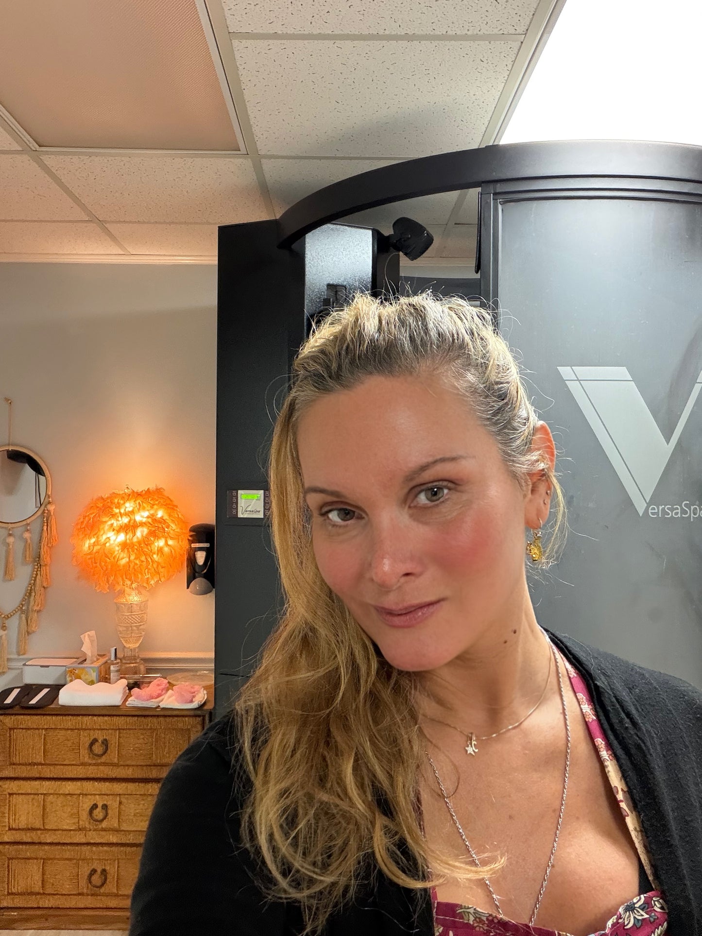 Woman inside VersaSpa spray tanning room in Berlin, MD (near Ocean City)