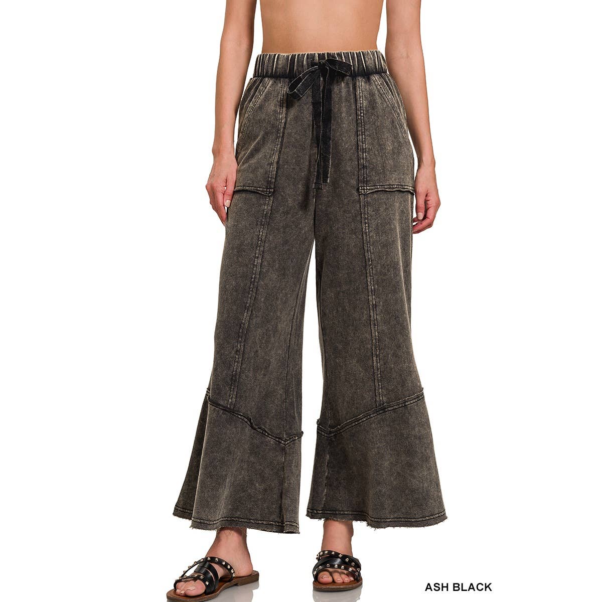 Drawstring waist and exposed seam flared pants in black