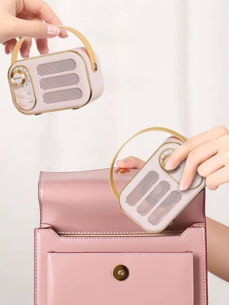 Girl putting Mini retro Bluetooth speaker into purse