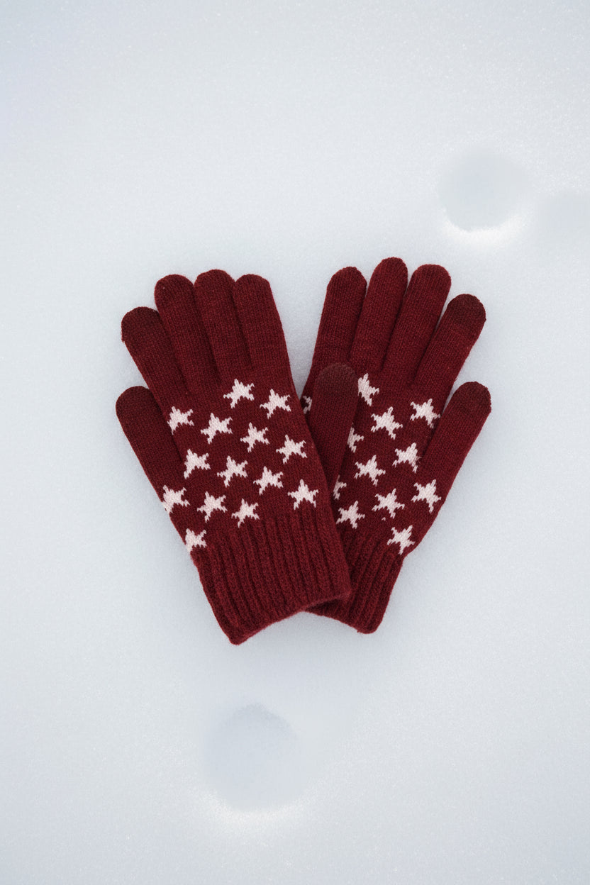 Pair of red gloves with white star patterns on a white background