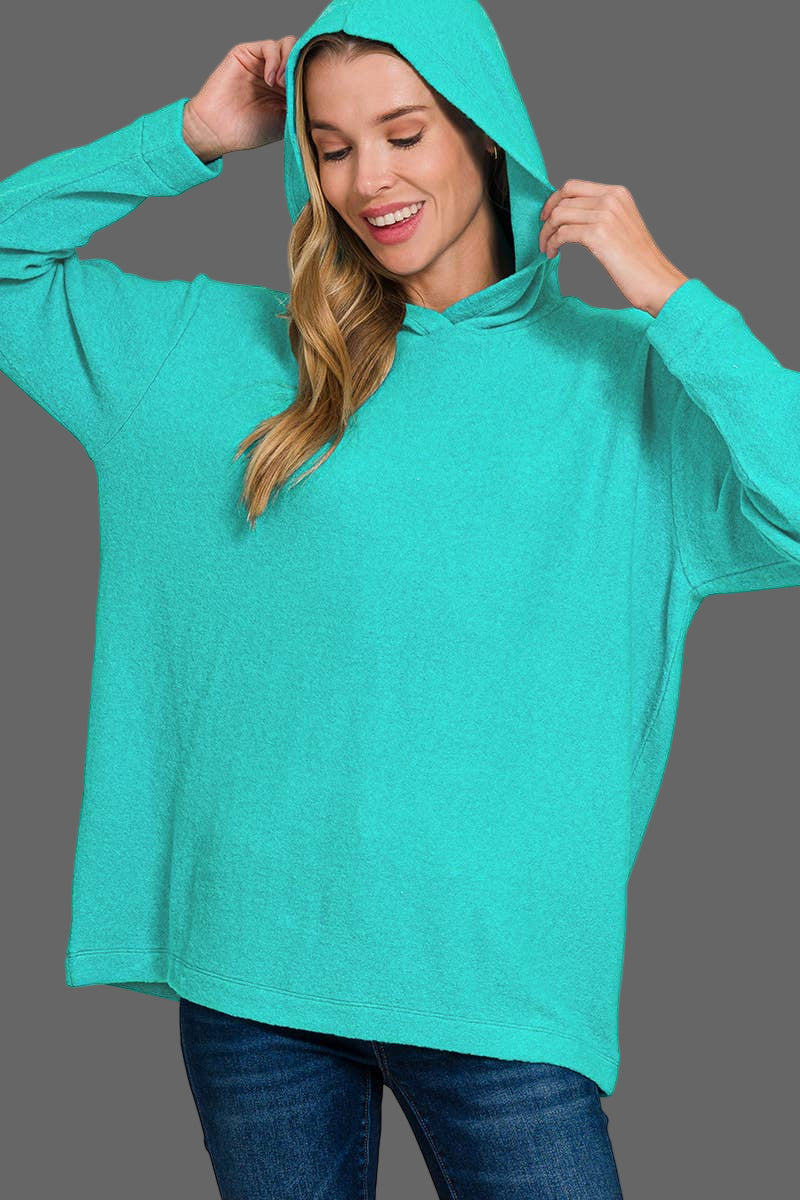 Woman wearing a teal hoodie with text indicating 'Brushed Micromersey Soft' and 'LT Teal'.