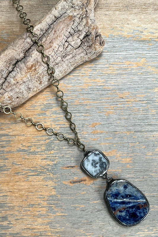 Necklace with blue stone pendants on a wooden surface