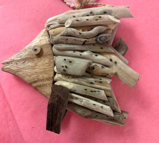 Driftwood fish sculpture ornament on a pink background in Berlin, MD near Ocean City, MD