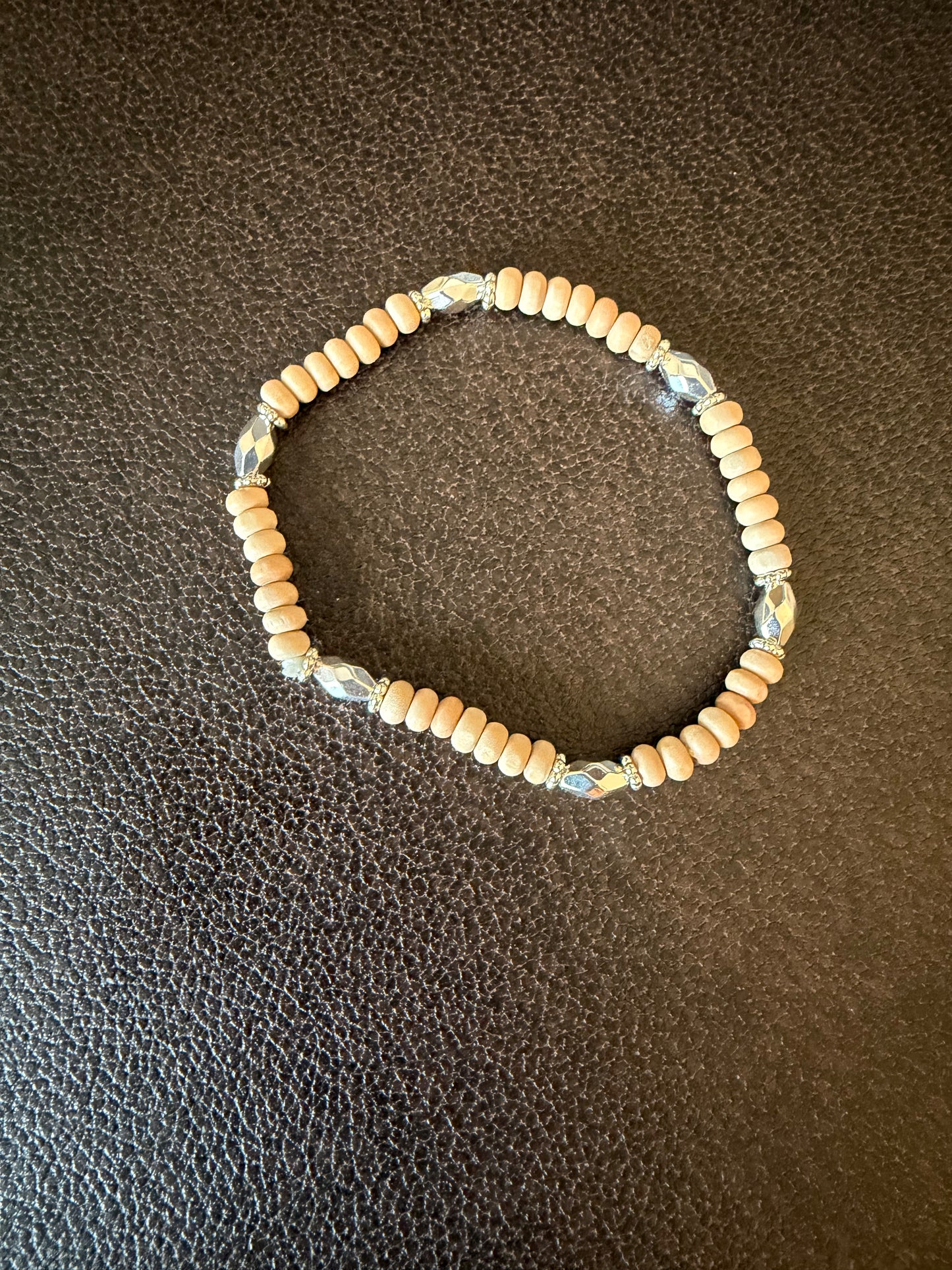 Wood bead bracelet on brown leather surface