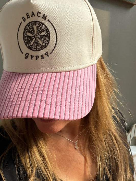 Beautiful woman showing a pink striped brim on a canvas Beach Gypsy trucker hat
