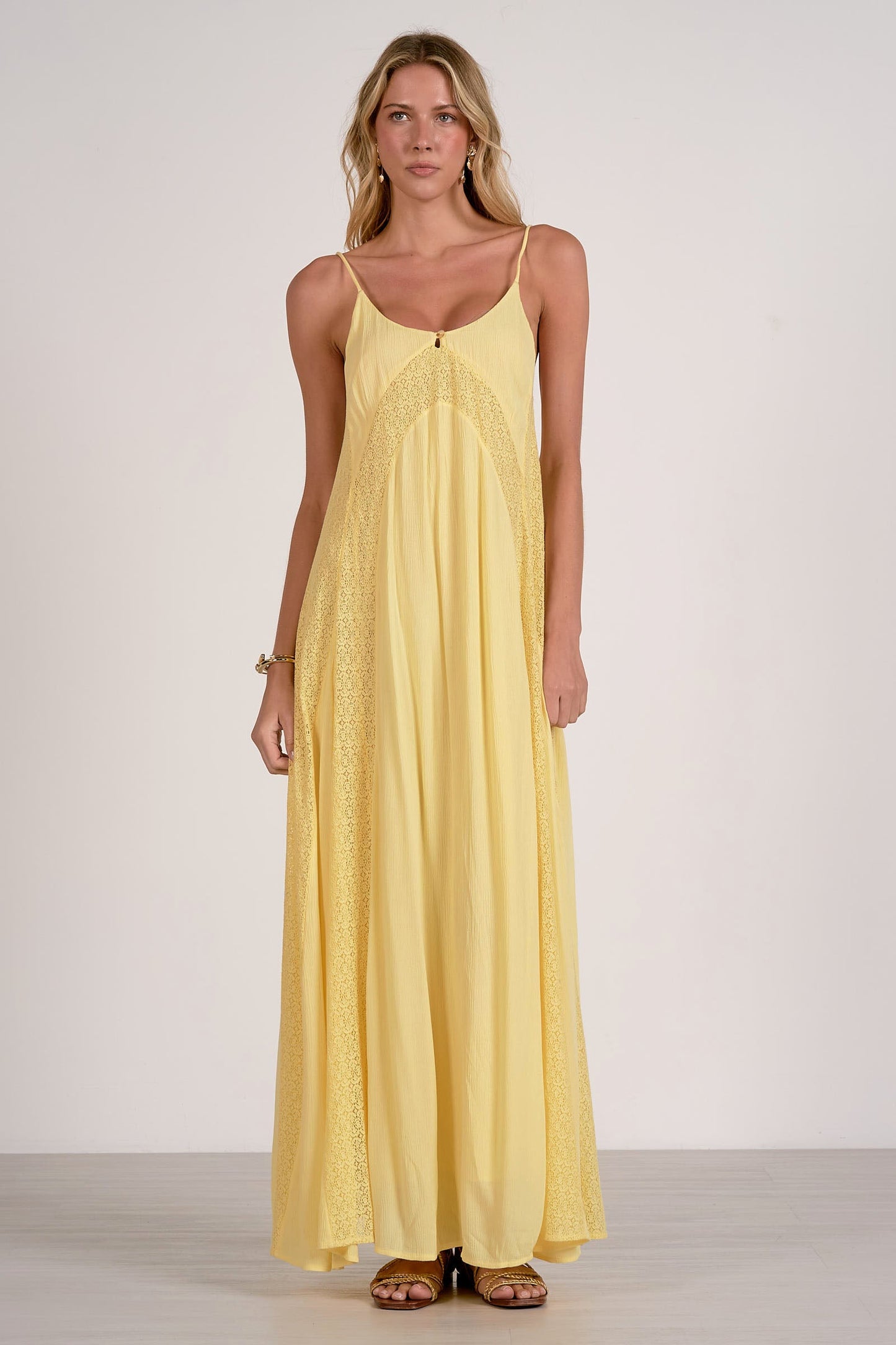 Woman wearing a yellow dress against a white background