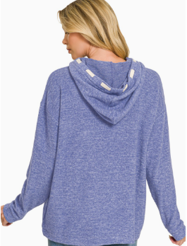 A woman shown from the back wearing a heathered blue hooded sweatshirt with white drawstrings, set against a plain white background.