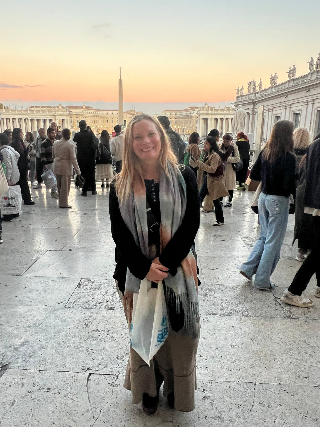 Woman standing on steps in Vatican City wearing a scarf