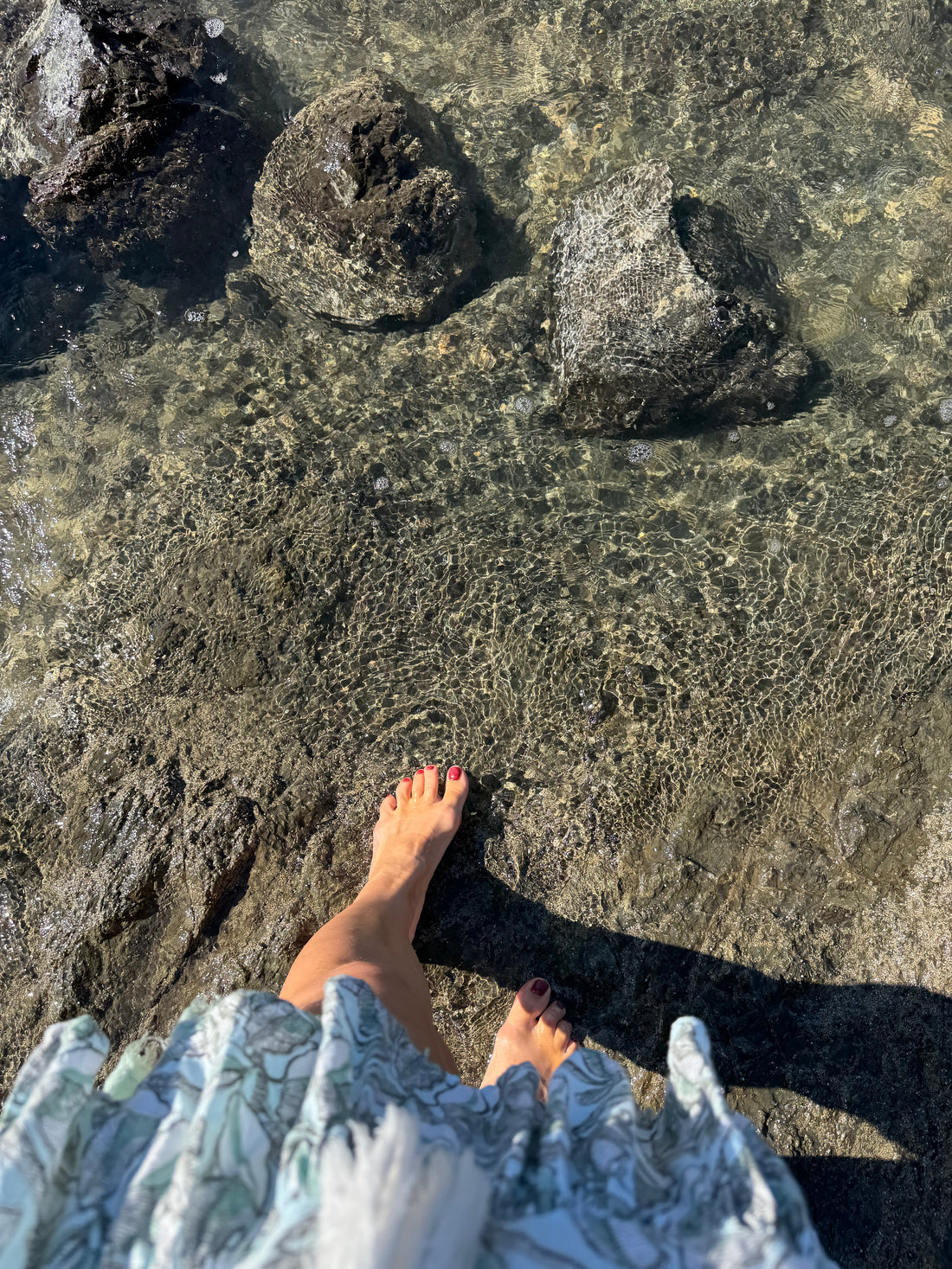 foot dipping into rippling water. 