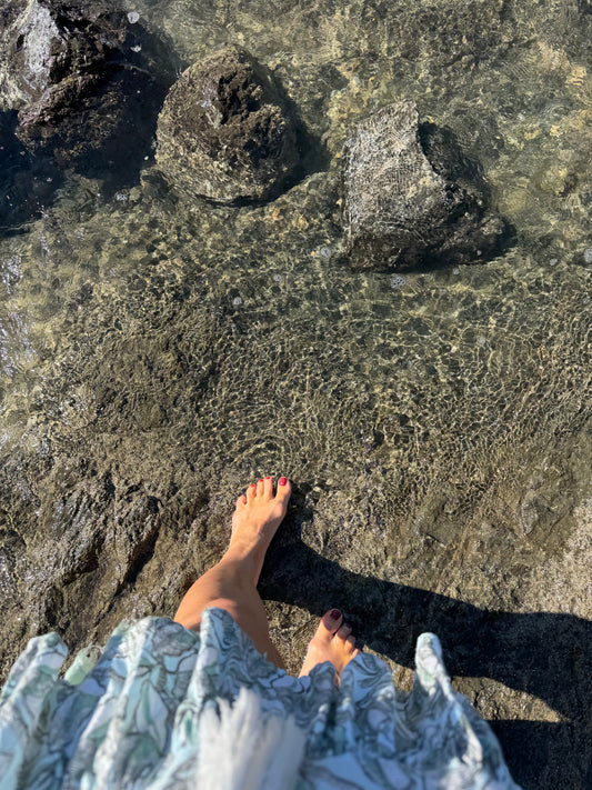 foot dipping into rippling water. 