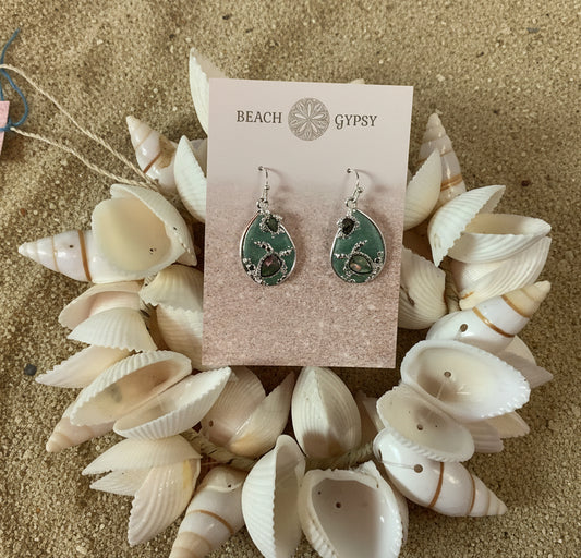 Earrings on a 'Beach Gypsy' branded card with seashells around