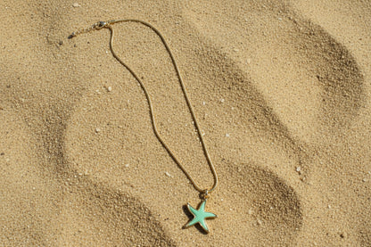 Necklace with a star-shaped pendant on a textured surface