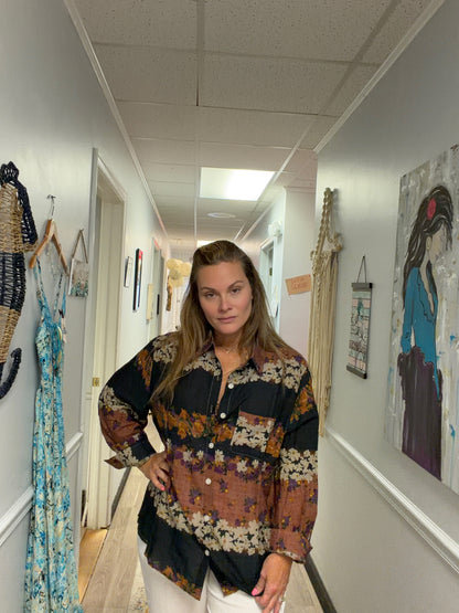 Woman wearing a brown floral striped button down shirt in a spa 