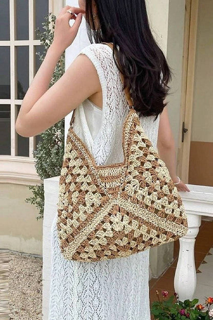 Woman carrying a large, patterned crochet bag outdoors.