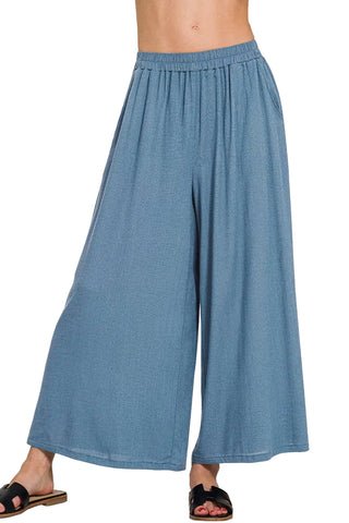 Blue denim wide-leg pants on a white background
