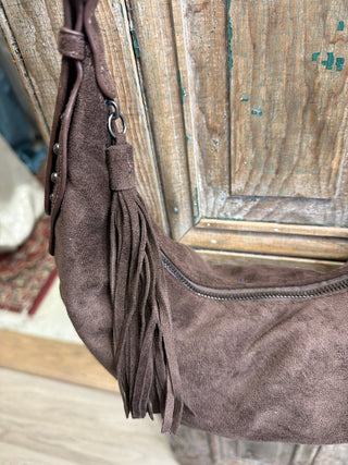 Close-up of brown suede-style half moon bag with fringe tassel and top zipper – Beach Gypsy