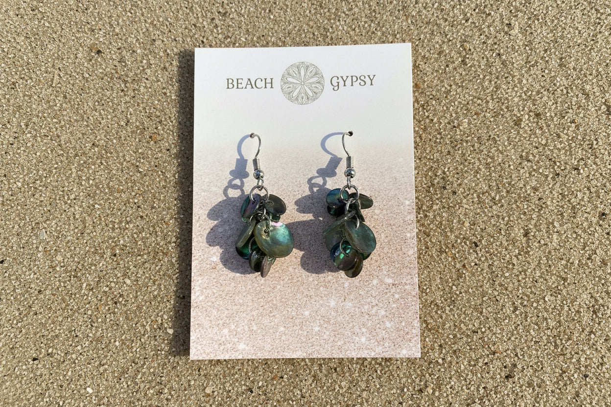 Pair of abalone confetti earrings on a 'Beach Gypsy' branded card against a pink background