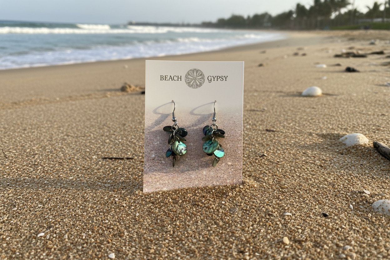Abalone dangle earrings on beach