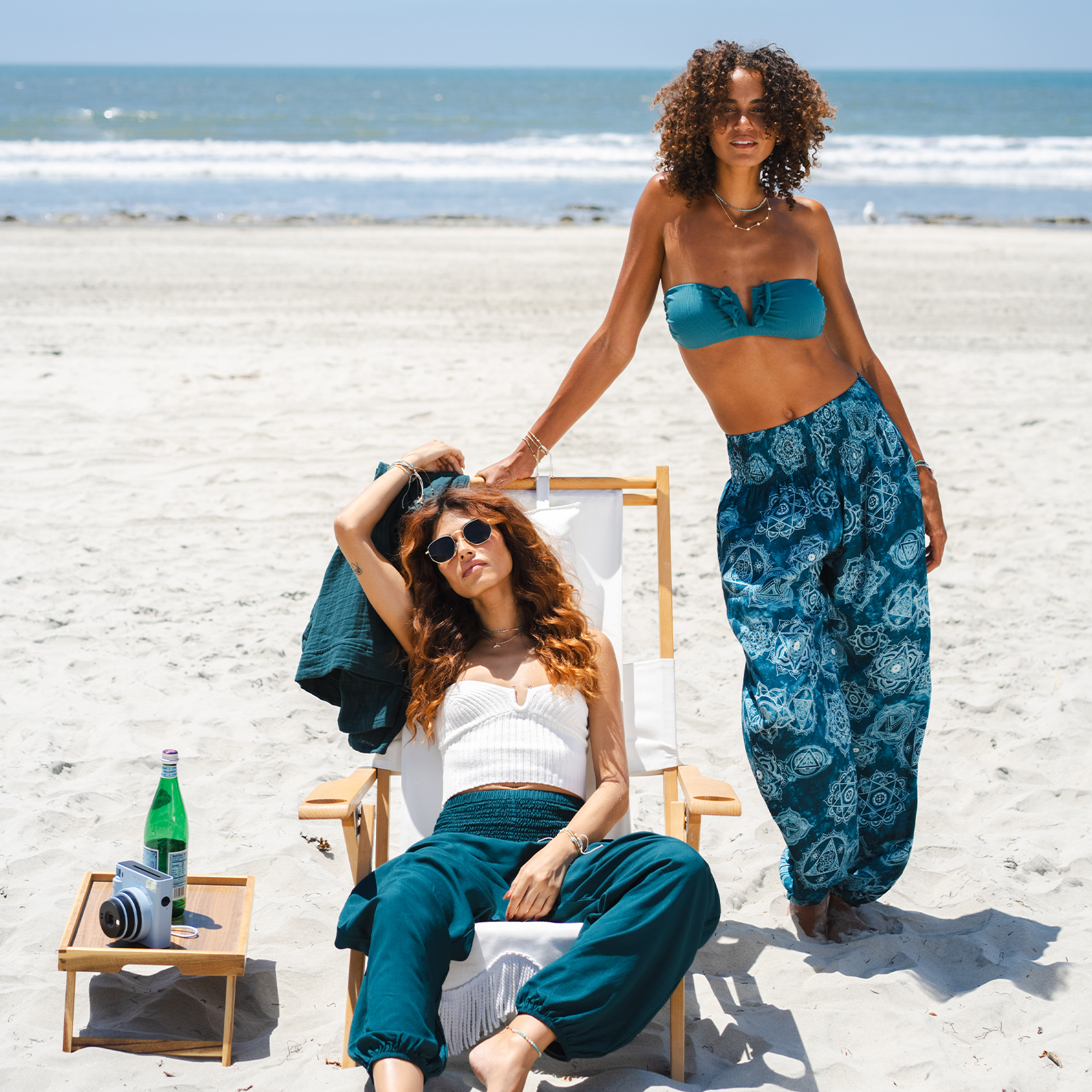 Relaxing girls in beach with pants on 