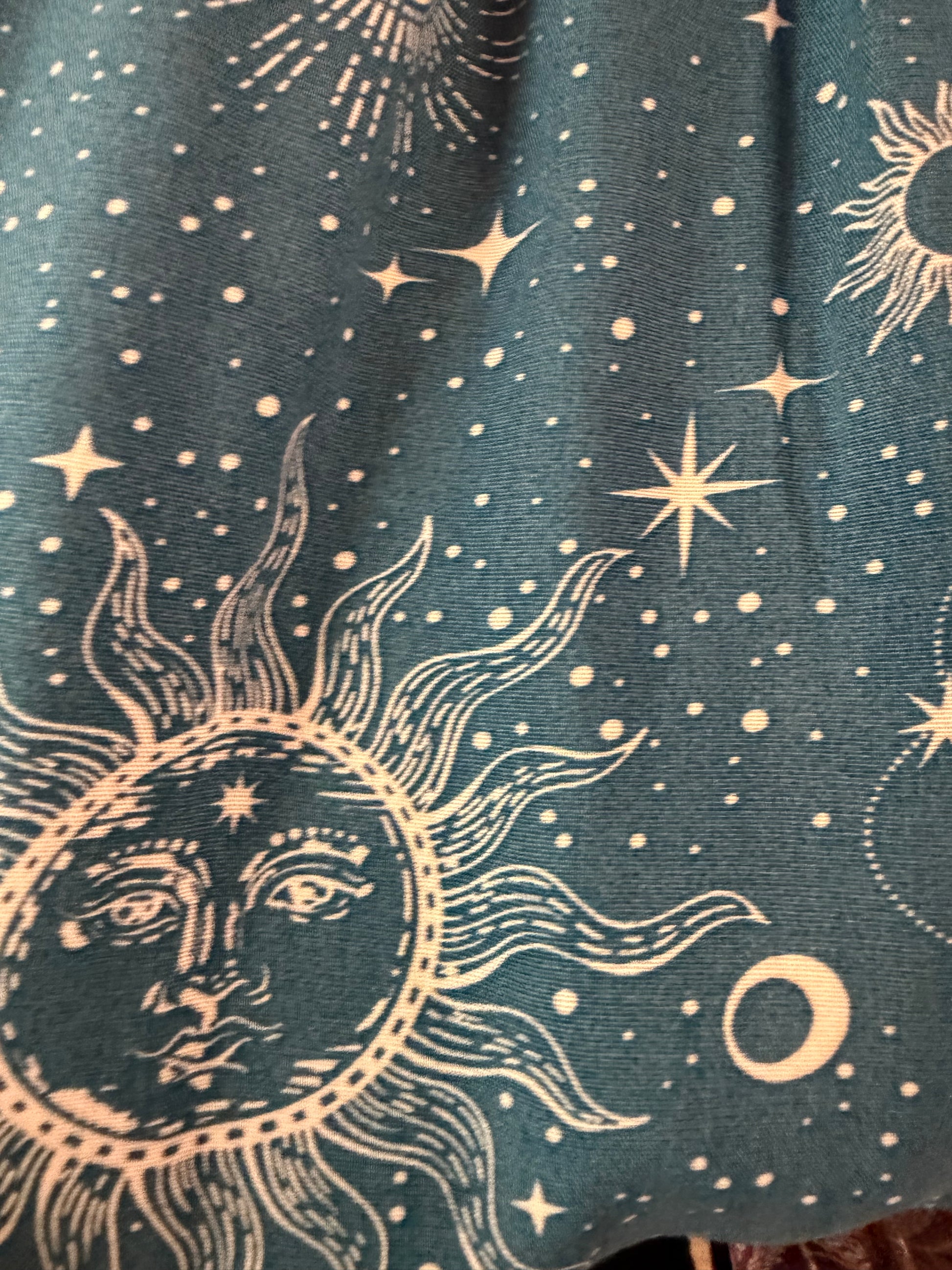 Closeup of fabric swatch of cosmic sky harem pants in blue