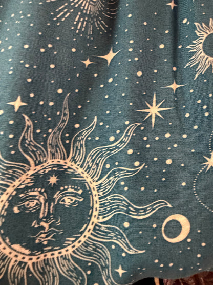 Closeup of fabric swatch of cosmic sky harem pants in blue