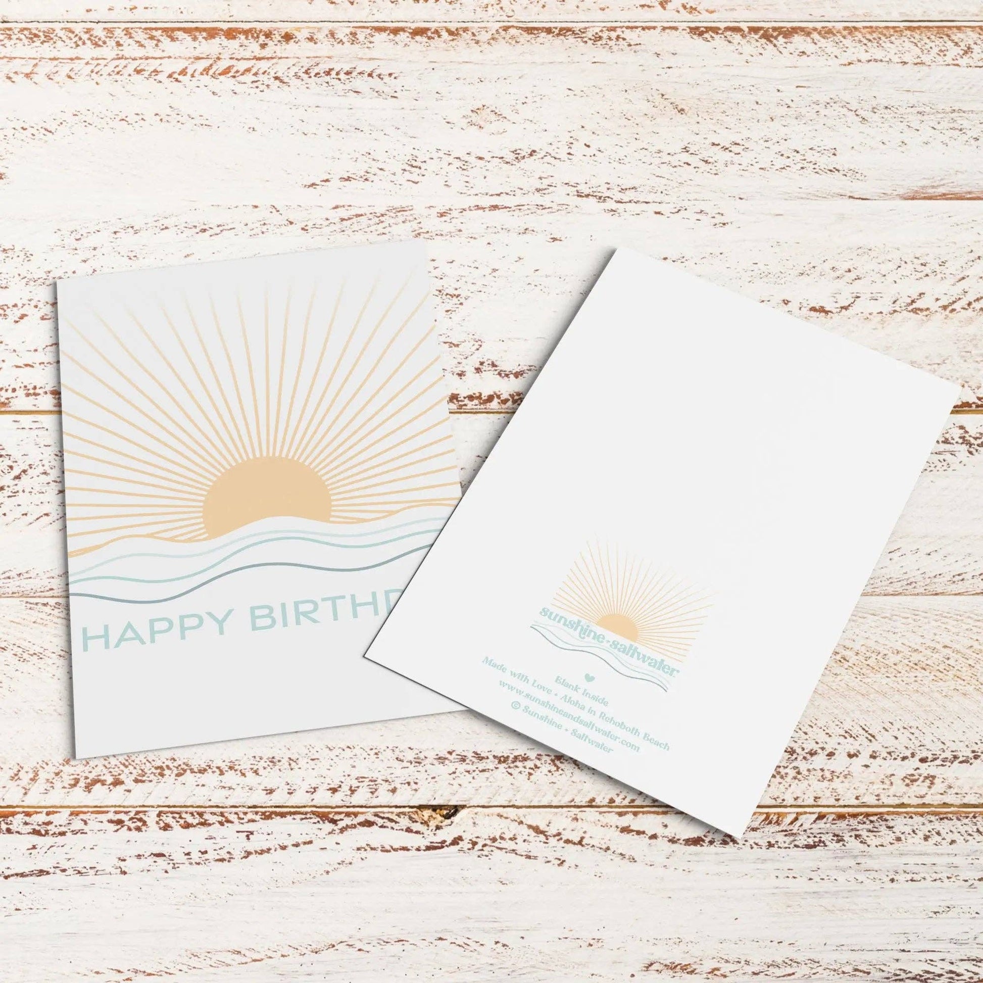 Birthday card with sun design on a wooden surface