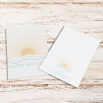 Birthday card with sun design on a wooden surface
