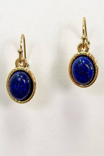 Pair of gold earrings with blue stones on a white background