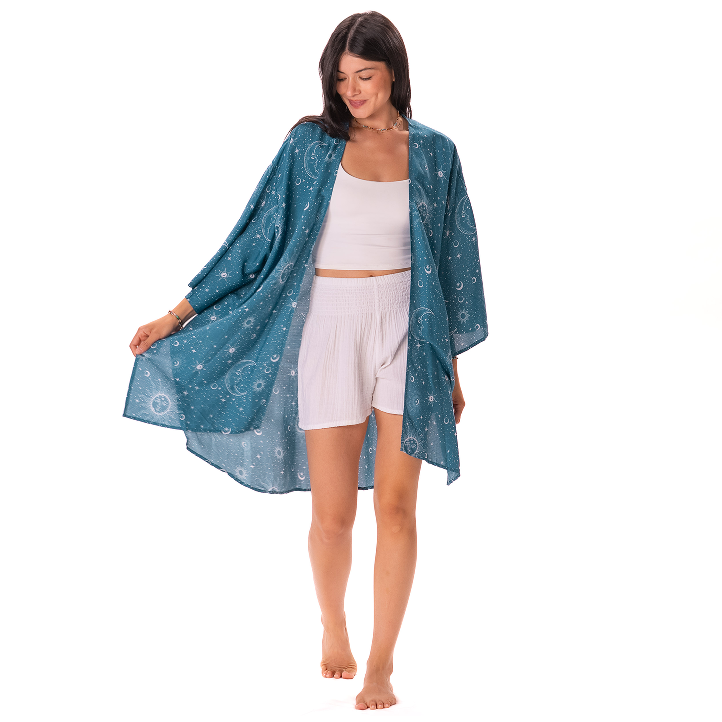 Woman wearing a blue patterned kimono over a white outfit on a white background