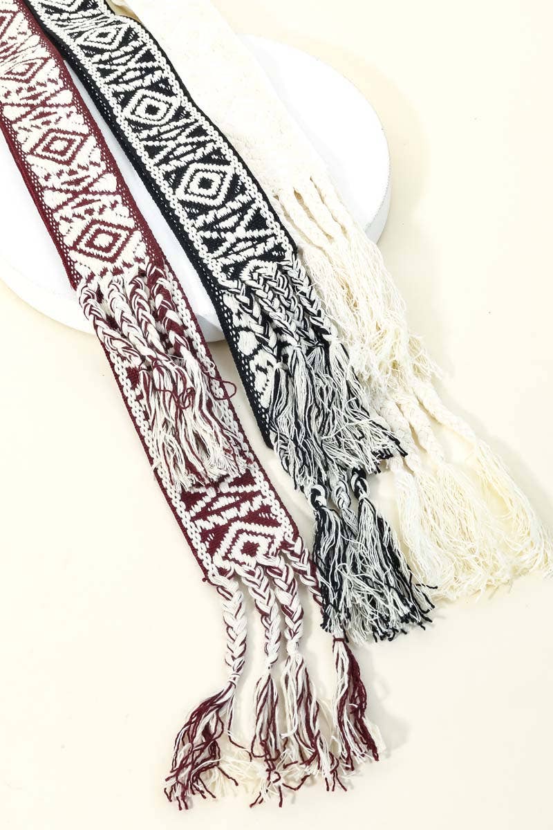 Decorative belt with tribal pattern and tassels on a white background