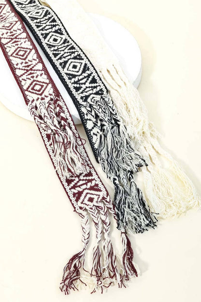 Decorative belt with tribal pattern and tassels on a white background