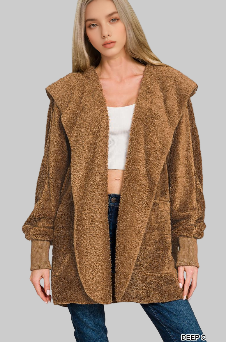 Woman wearing a deep camel faux fur coat on a white background