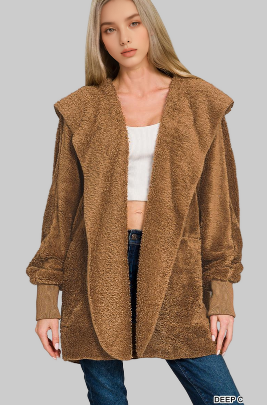 Woman wearing a deep camel faux fur coat on a white background