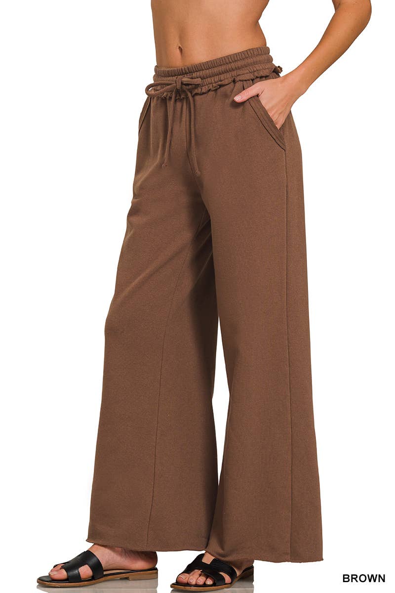 Brown wide-leg pants worn by a person on a white background