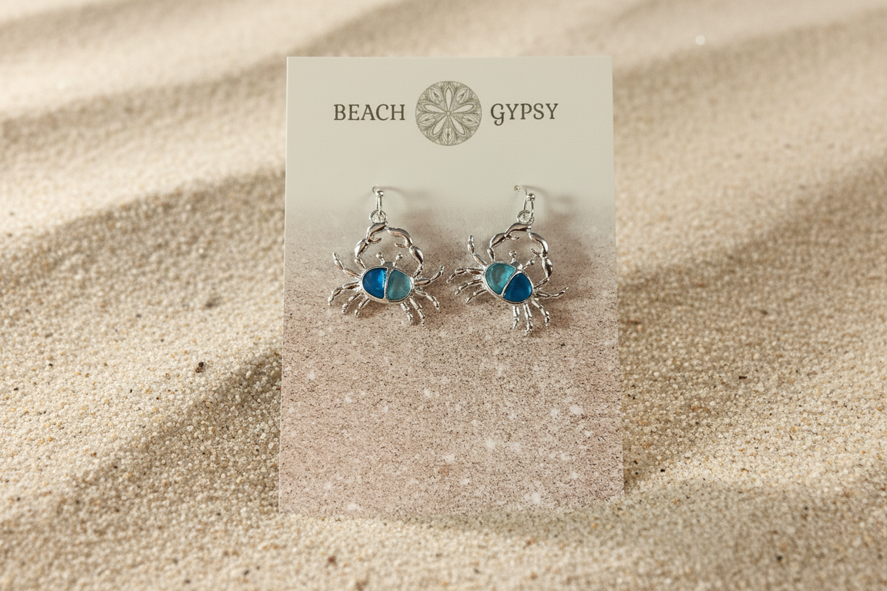 Blue crab dangle earrings on Sandy background 
