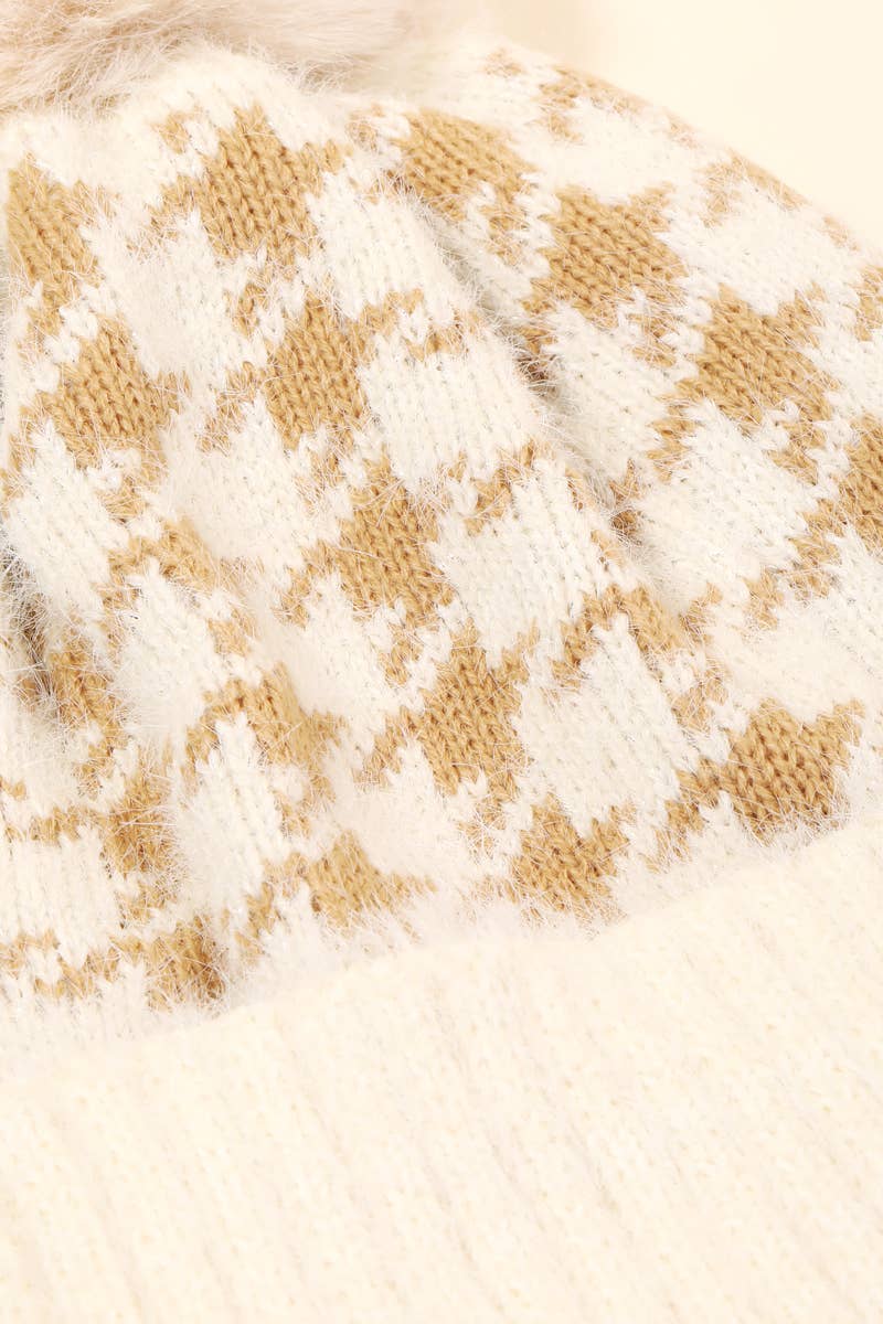 Close-up of a textured fabric with a houndstooth pattern in beige and white.