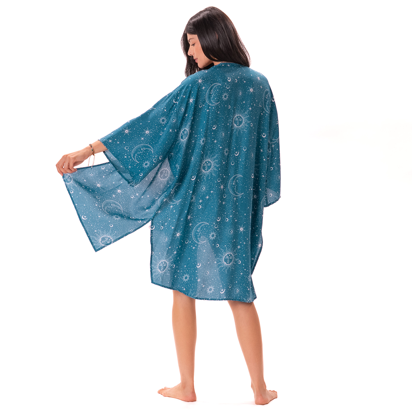 Woman wearing a blue kimono-style garment with celestial designs on a white background