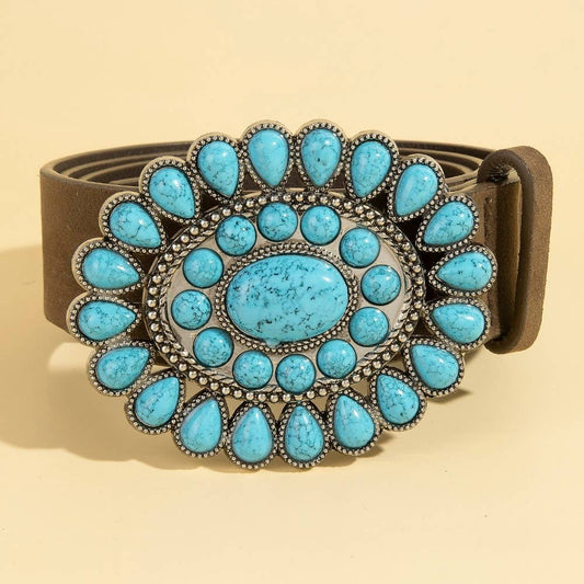 Belt with a turquoise stone buckle on a beige background
