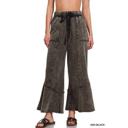 Drawstring waist and exposed seam flared pants in black