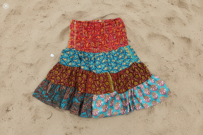 Colorful tiered skirt on a sandy surface