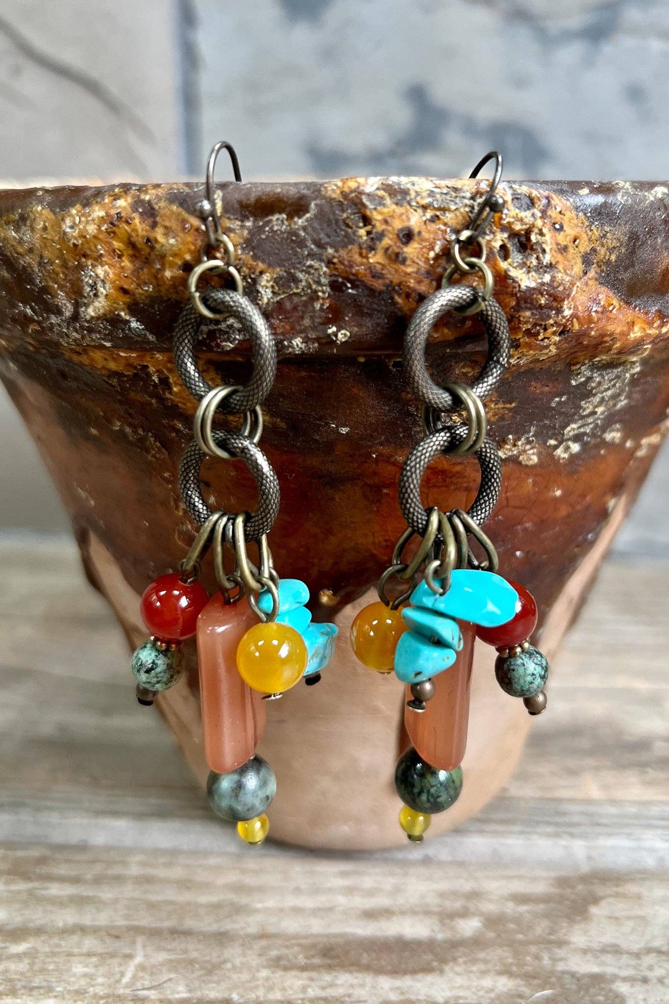 Earrings with colorful beads on a wooden surface