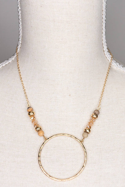 Necklace with a gold hoop pendant on a mannequin bust.