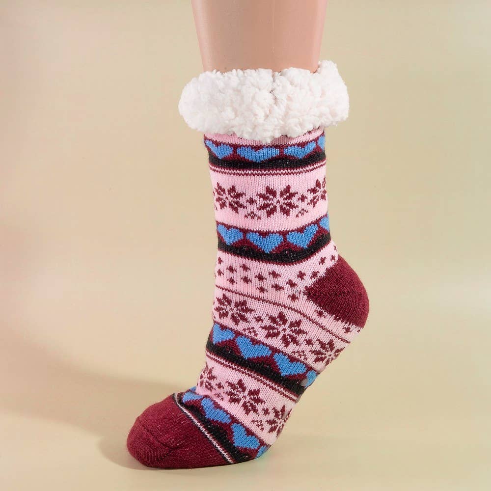 Colorful patterned socks with white fuzzy cuff on a beige background