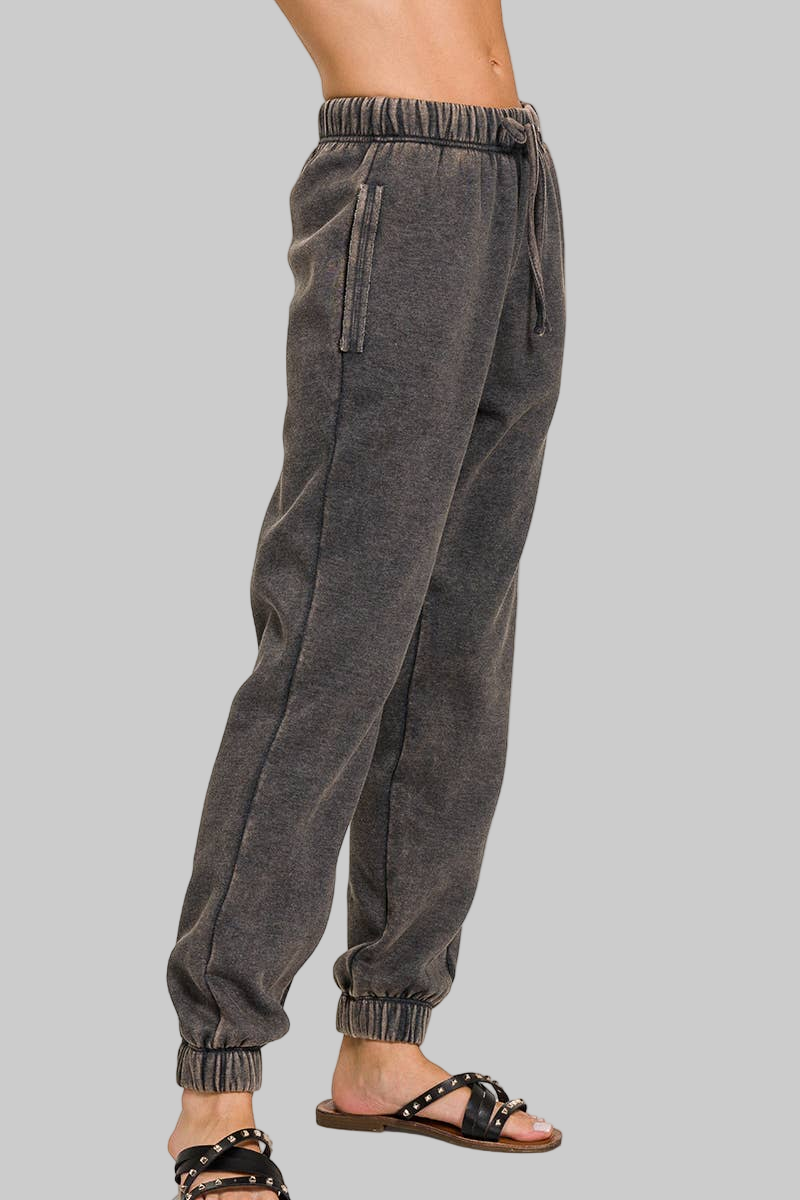 Ash black acid wash jogger pants on a white background