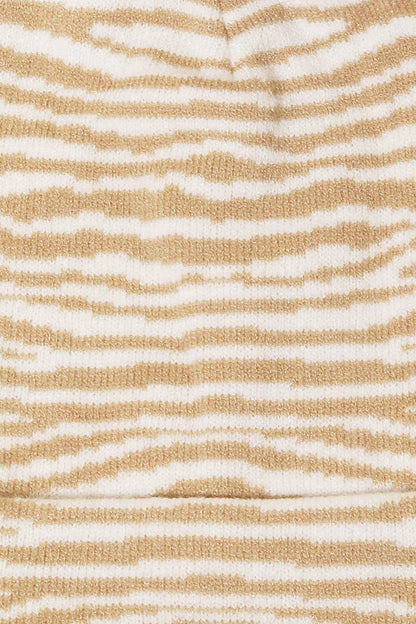 Textured fabric with wavy beige and white pattern