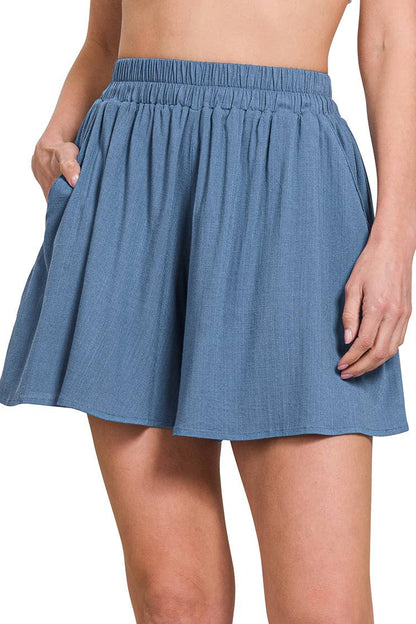 Blue denim sHORTS worn by a person on a white background