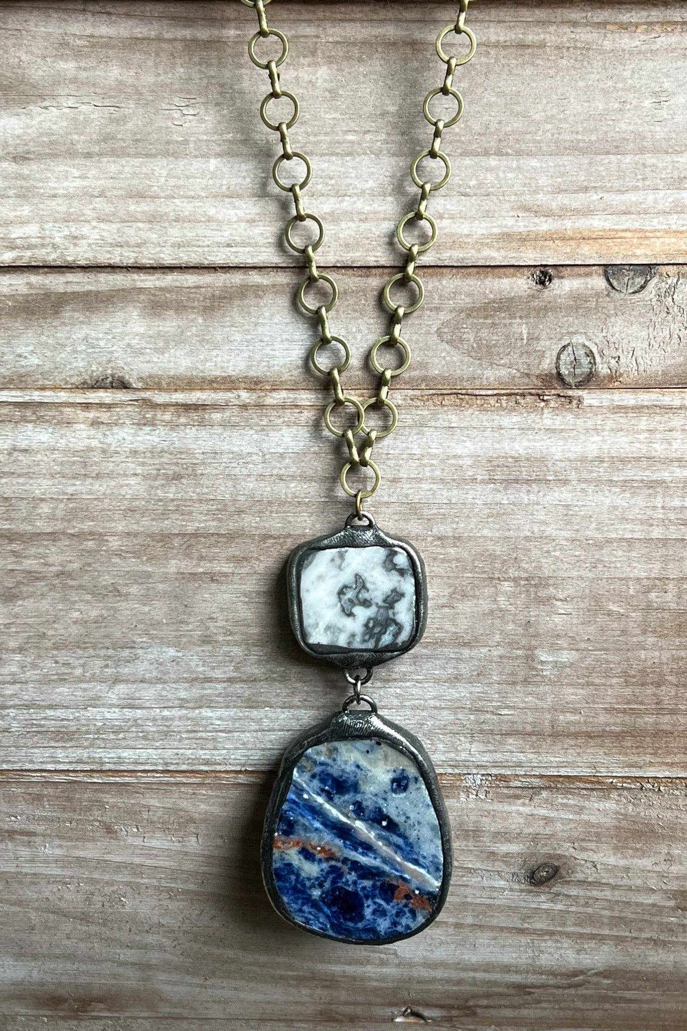 Necklace with a blue and white stone pendant on a wooden surface