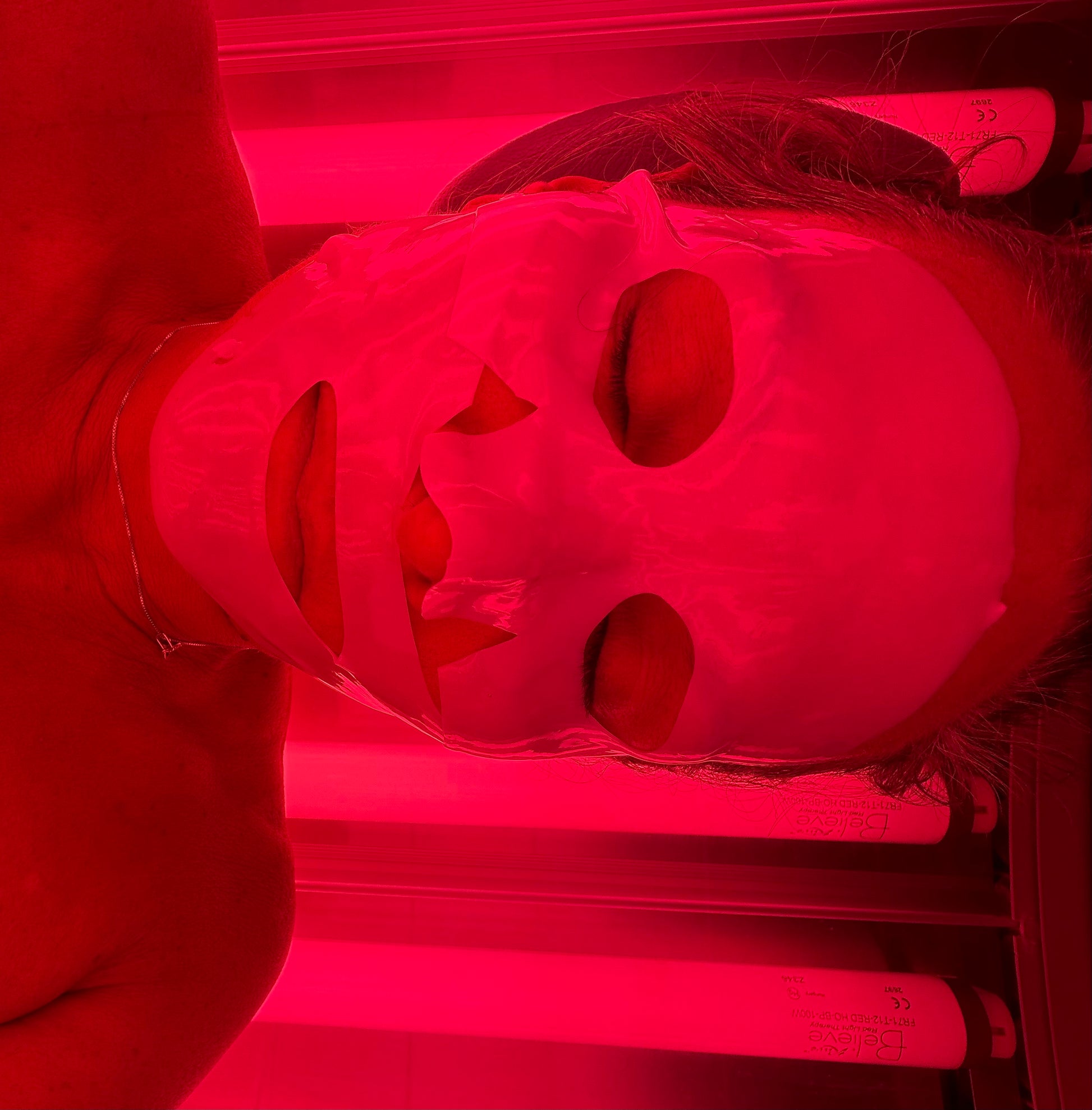 Woman wearing a collagen enhancing face mask with a red light  therapy session at Beach Gypsy in Nerlin, MD near Ocean City